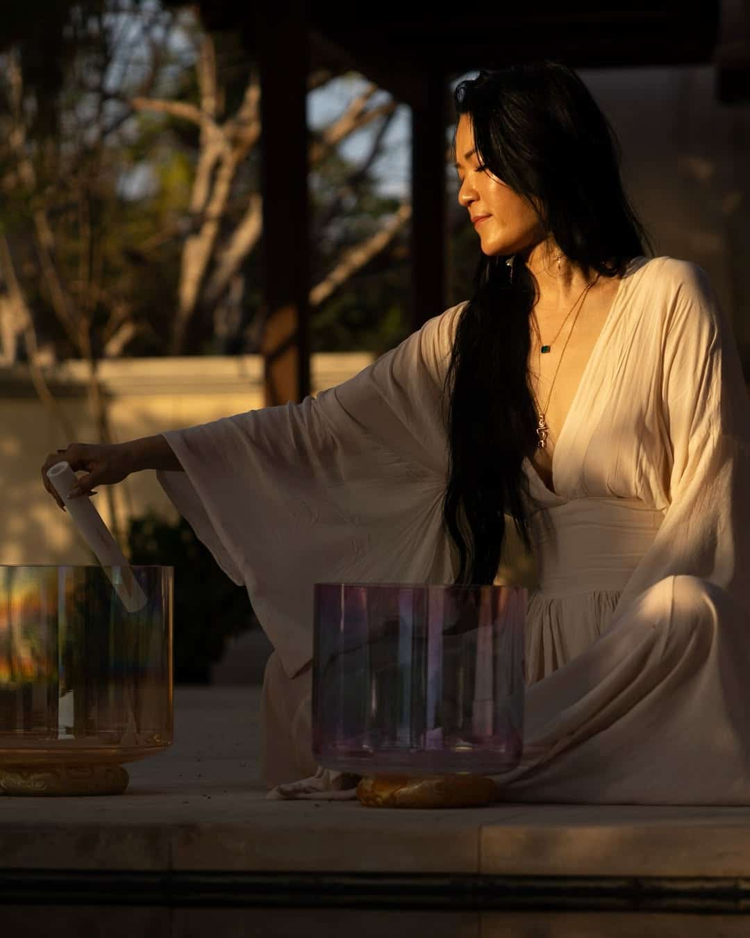 Ayi surrounded by sound healing instruments in Nosara