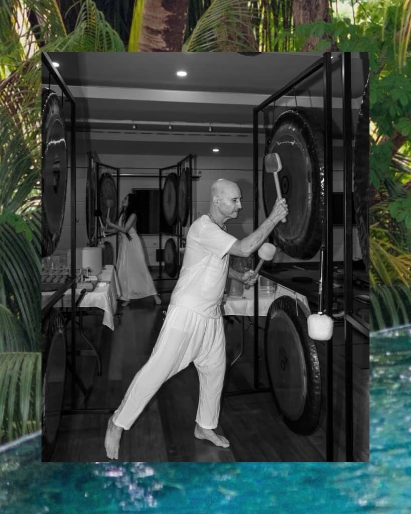 Michael facilitating immersive sound healing with gong instruments in Nosara